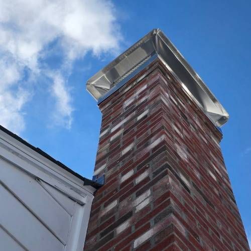 A brick chimney with a blue sky in the background