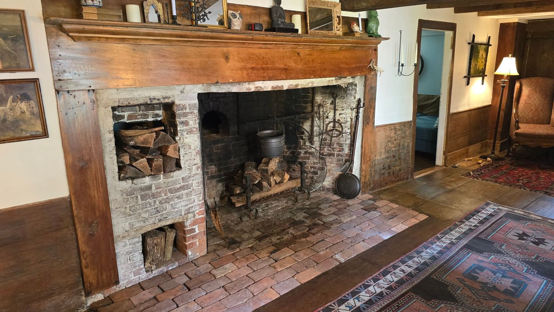 A living room with a fireplace and a rug.