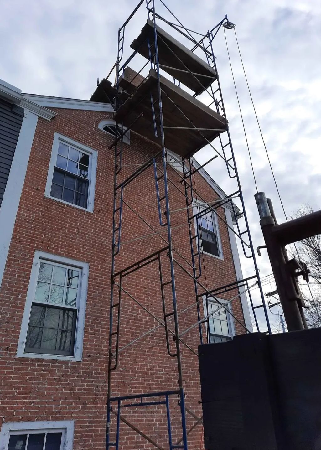 A brick building with scaffolding on the side of it