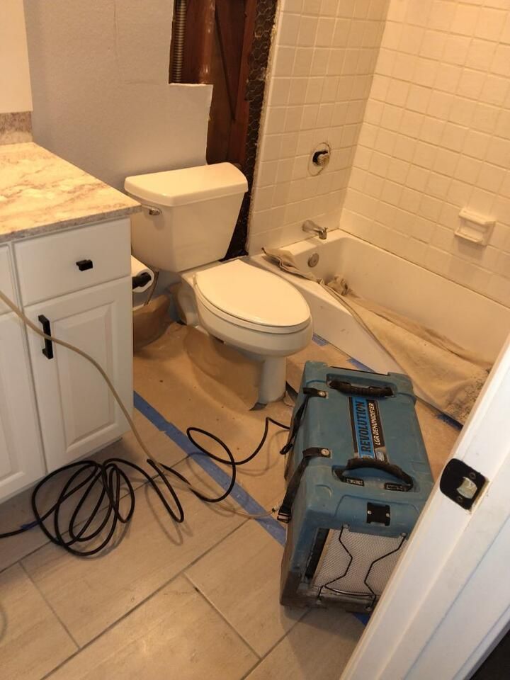 A bathroom with a toilet , sink , and bathtub.