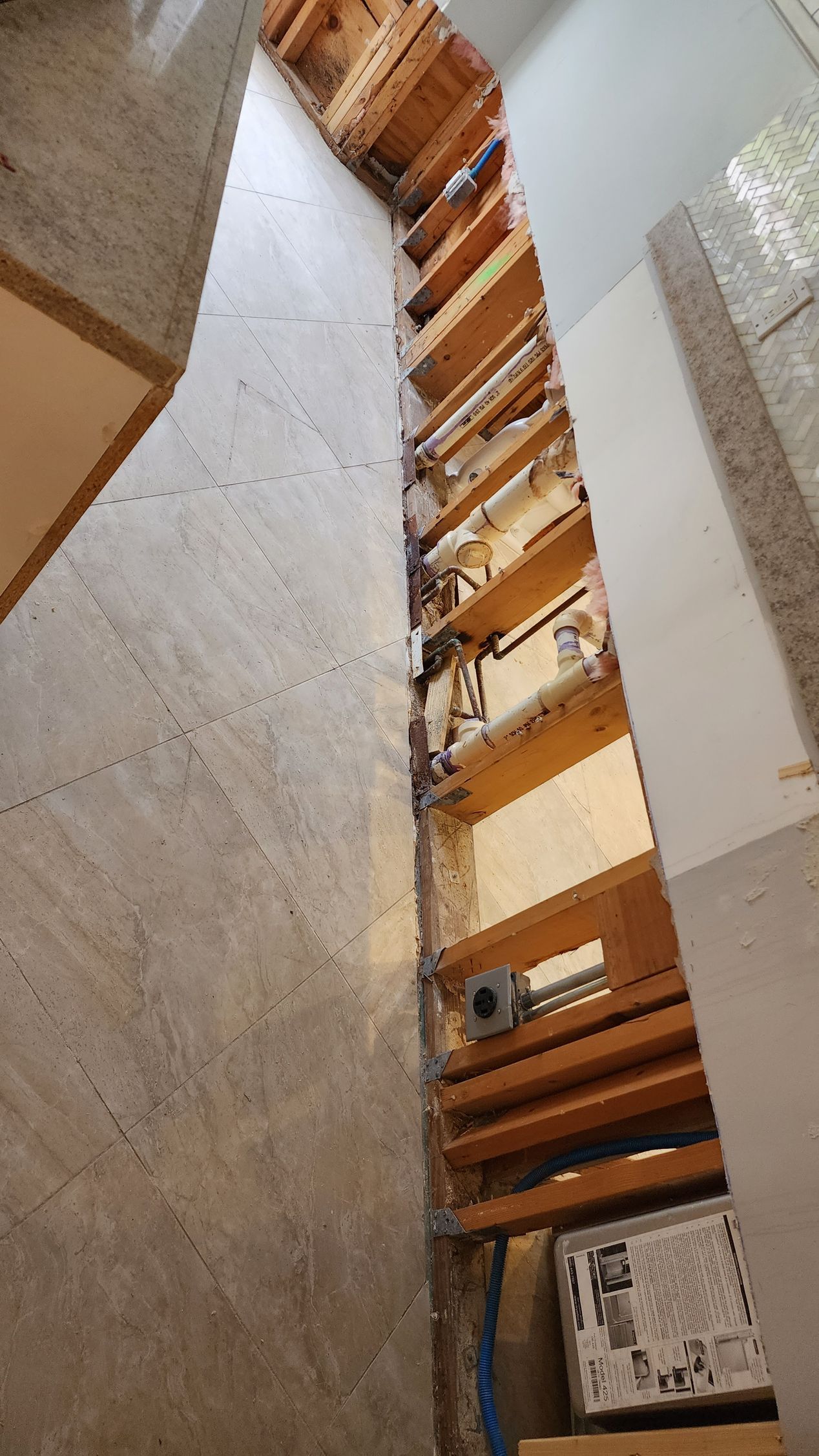 A row of wooden stairs going up a concrete wall in a room.