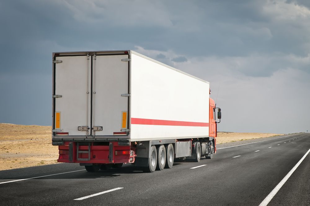 A White Semi Truck is Driving Down a Highway — R2B Heavy Vehicle Driving School in Mackay, QLD
