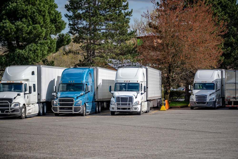 A Row of Semi Trucks Are Parked in a Parking Lot — R2B Heavy Vehicle Driving School In Rural View, QLD