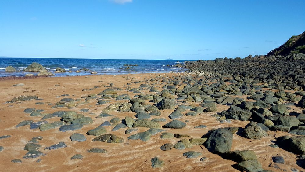 A Rocky Beach With a Blue Ocean in the Background — R2B Heavy Vehicle Driving School in Sarina, QLD