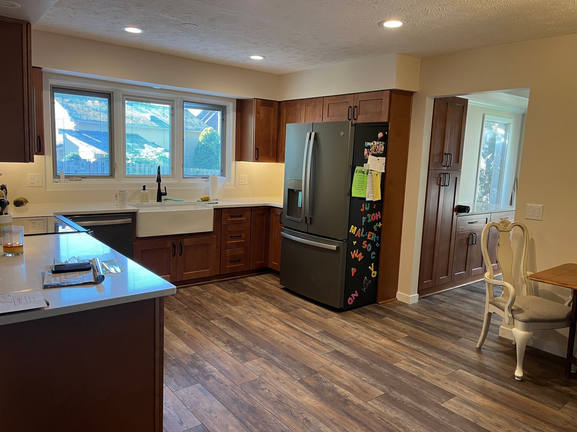 A kitchen with a refrigerator , sink , and dishwasher.