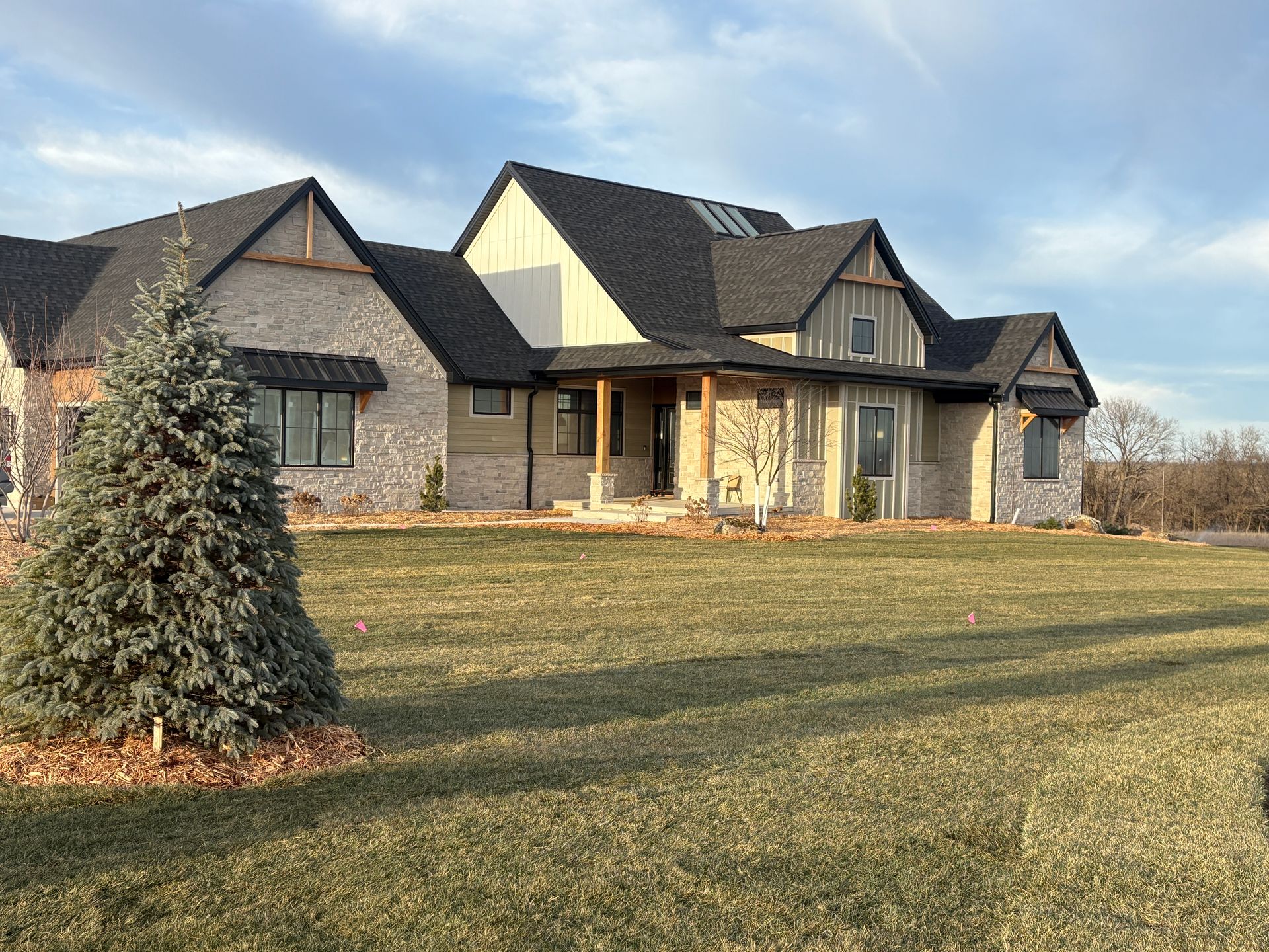 A large house with a christmas tree in front of it