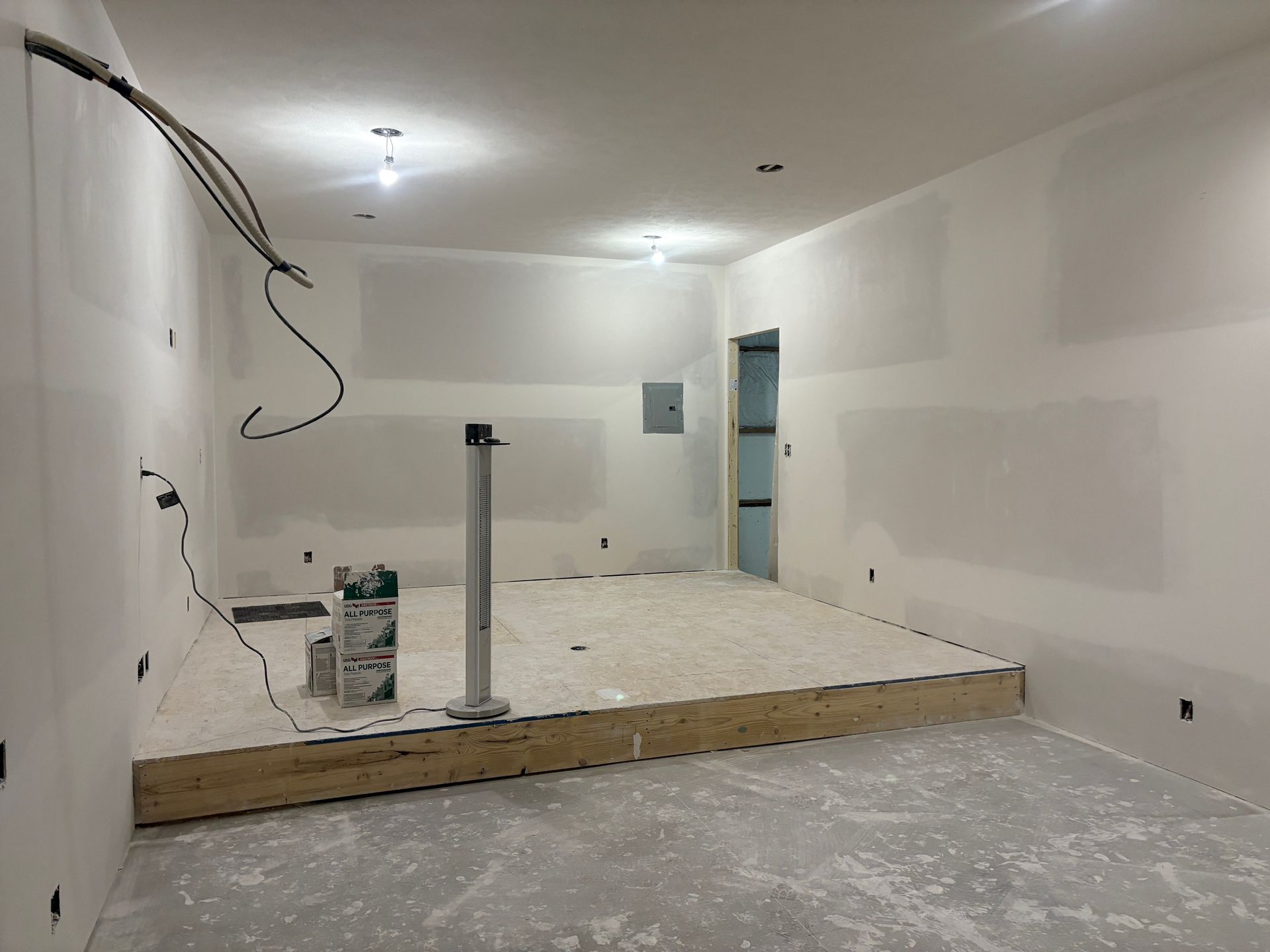 A room with white walls and a wooden floor