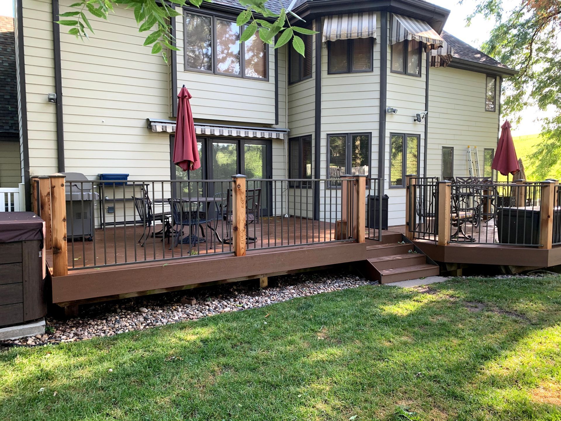 A large house with a large deck in front of it.