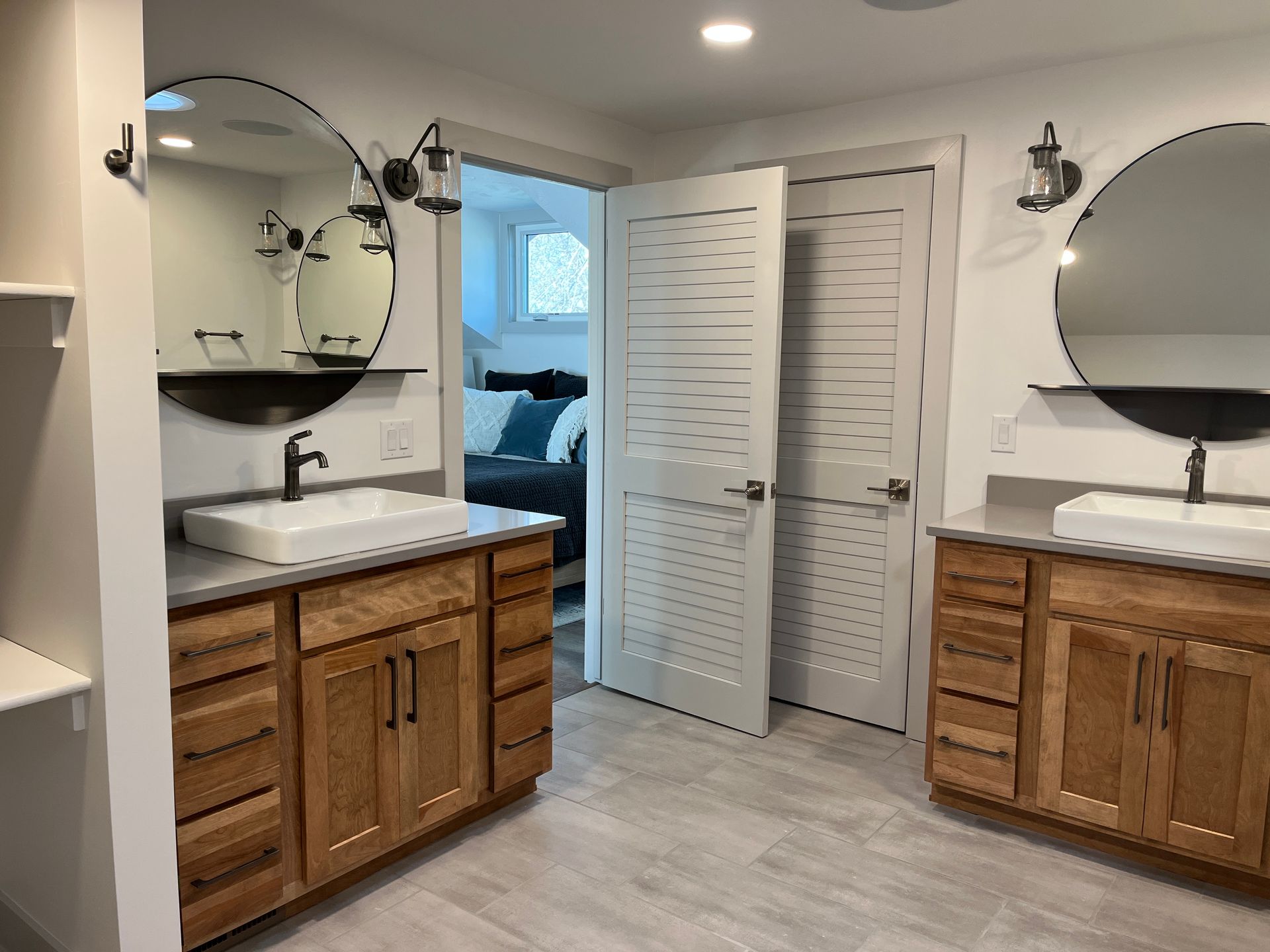 A bathroom with two sinks and two mirrors.