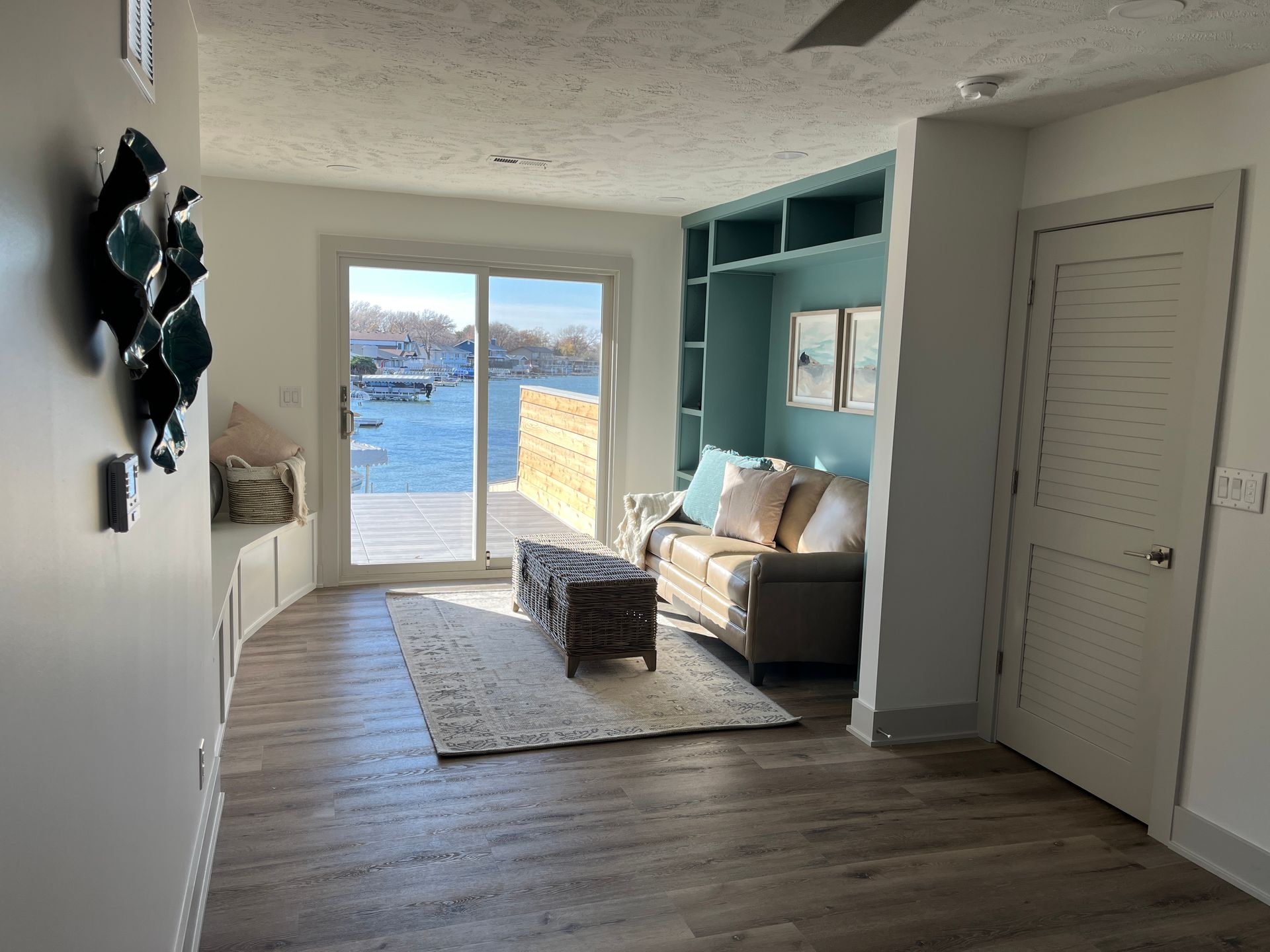 A living room with a couch and a view of the water.