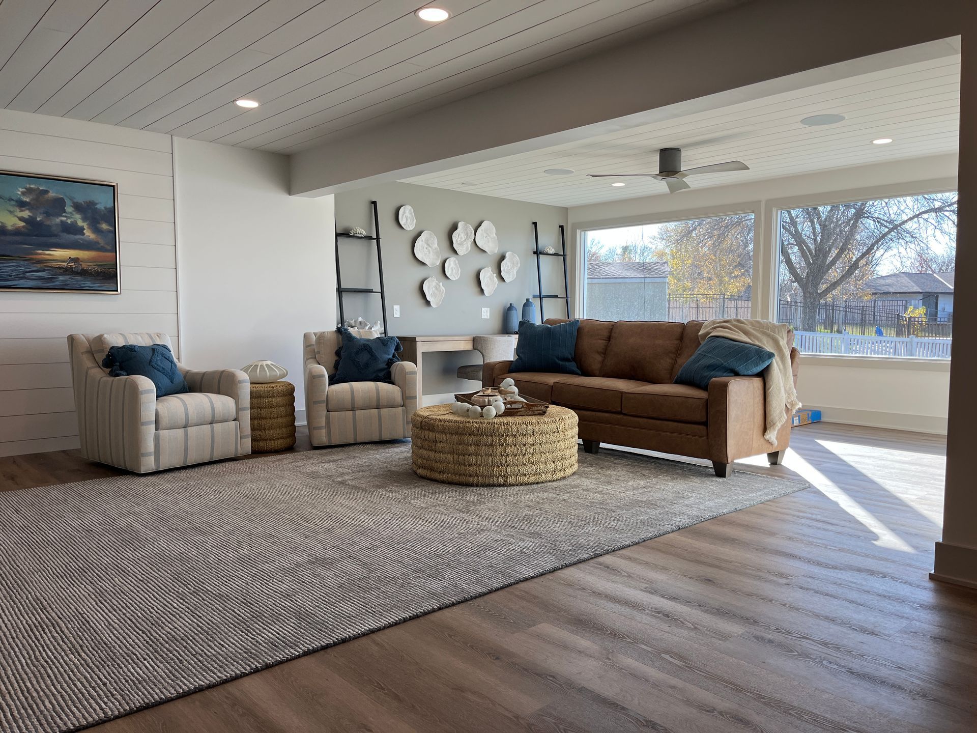 A living room with a couch , chairs , and a coffee table.