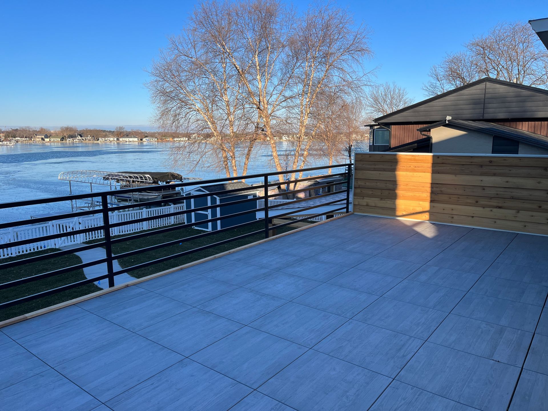 A balcony overlooking a body of water with trees in the background