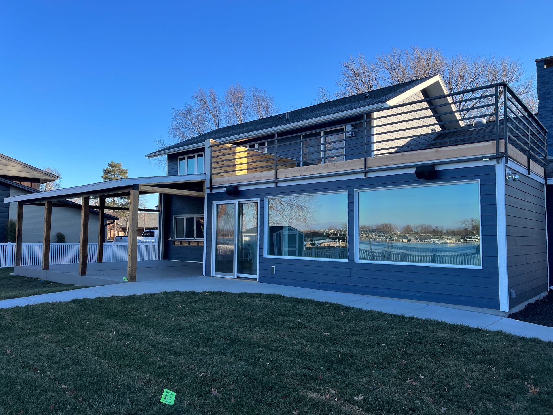 A large house with a lot of windows and a large lawn in front of it.