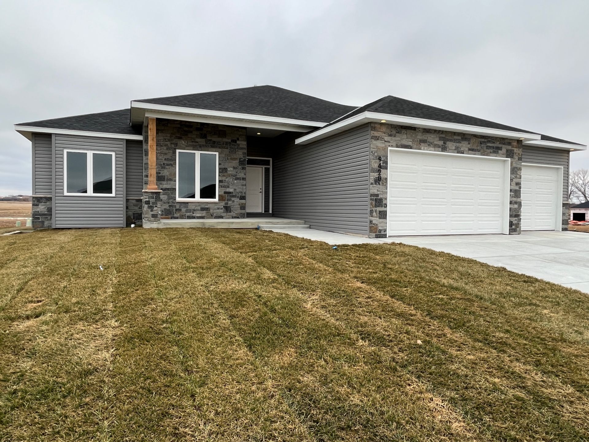 A large house with a lot of grass in front of it.