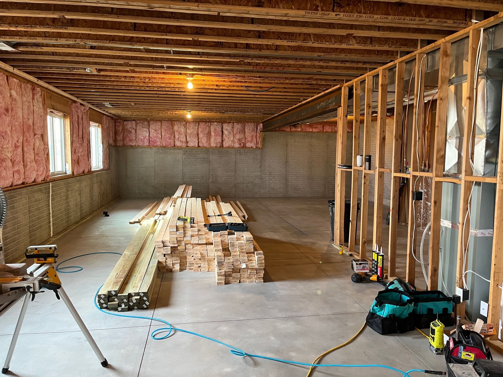A large room with a lot of wood and tools in it.