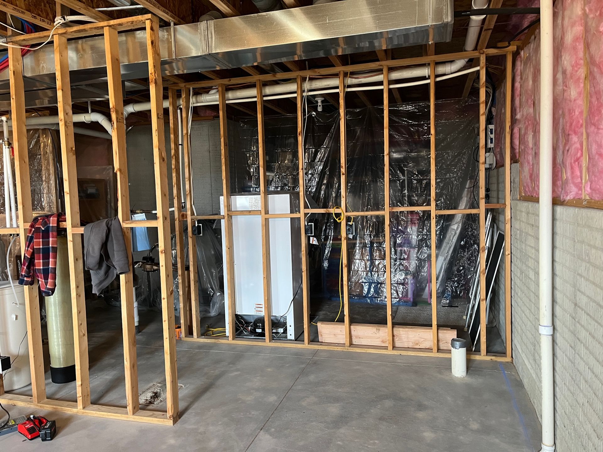 A room with a lot of wooden frames and a brick wall.