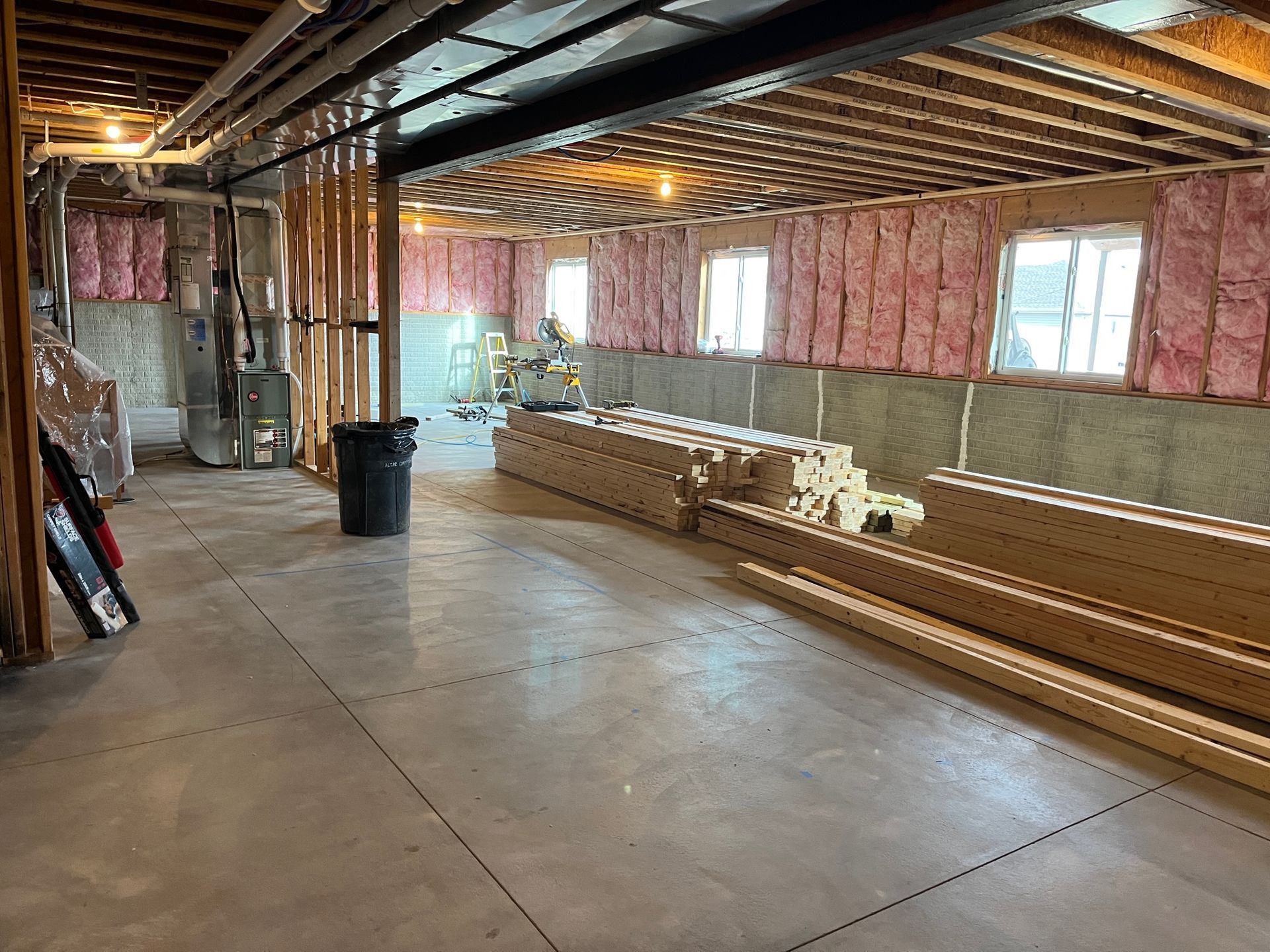 A basement under construction with a lot of wood and insulation.