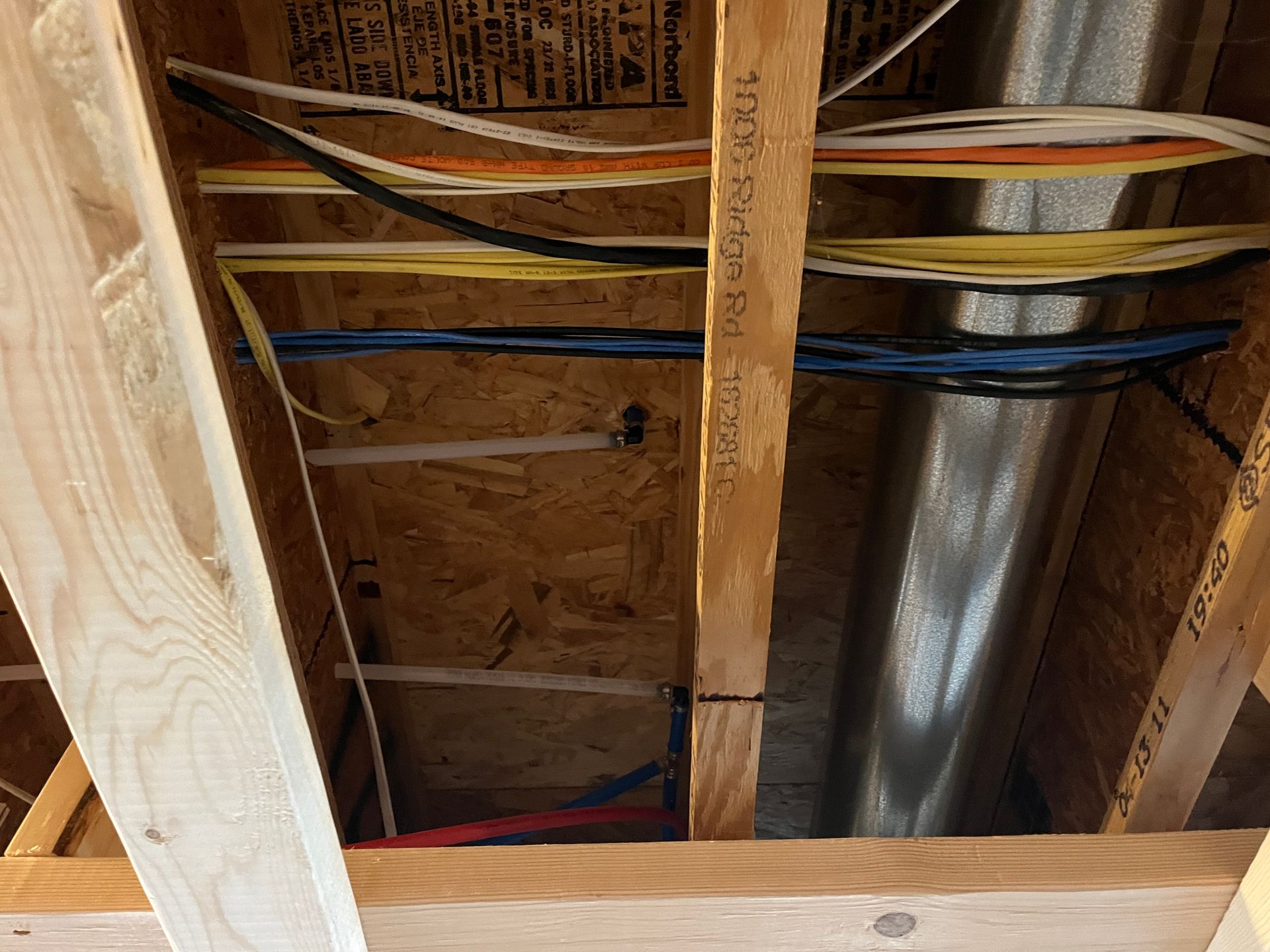 A bunch of wires are hanging from the ceiling of a building.