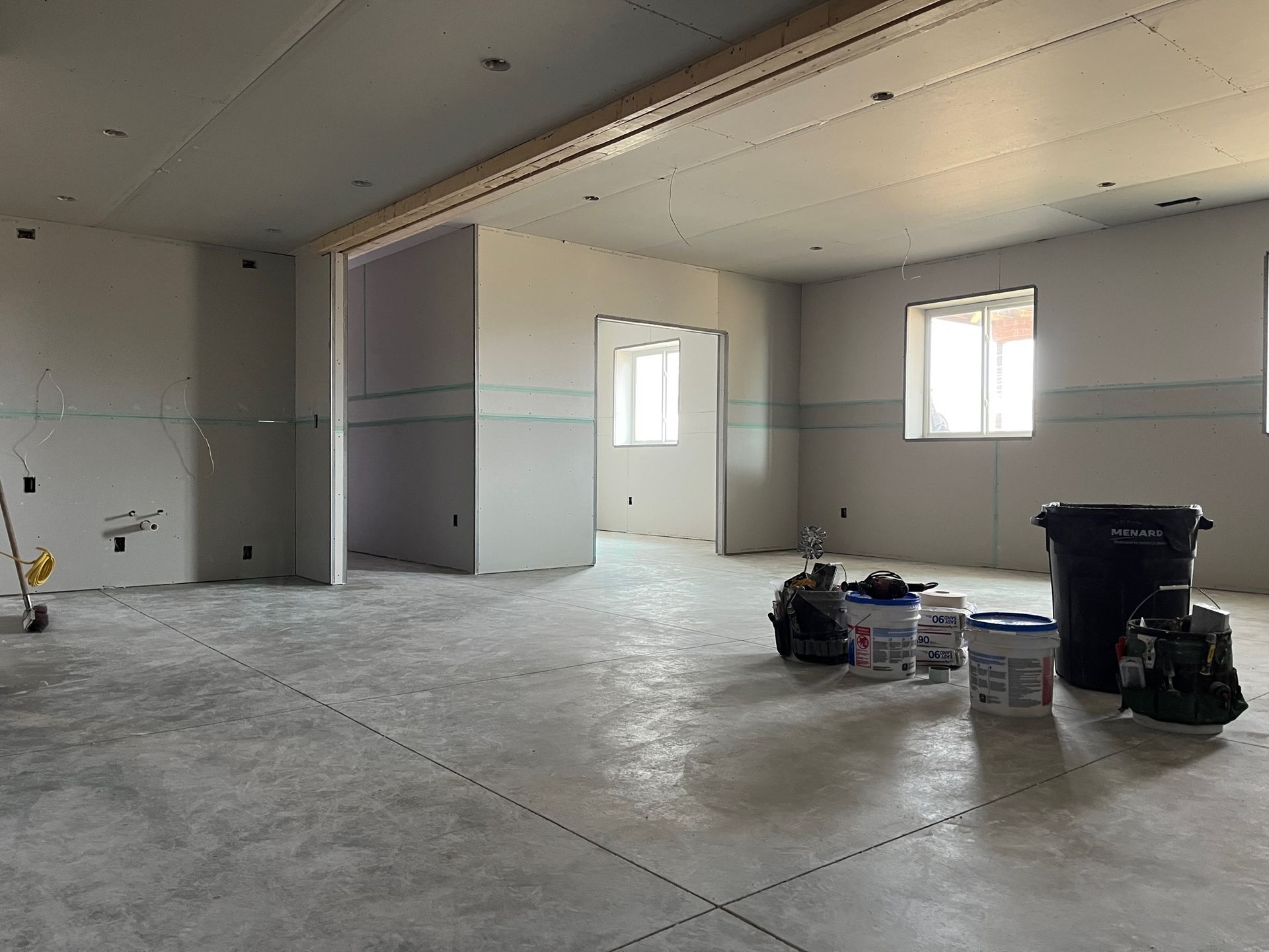 A large empty room with a lot of tools on the floor.