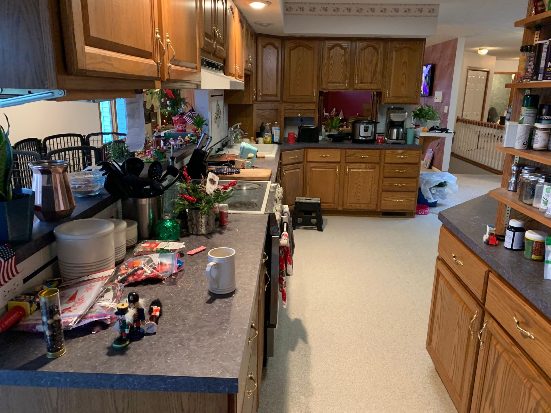 A kitchen with wooden cabinets , a sink , and a stove.