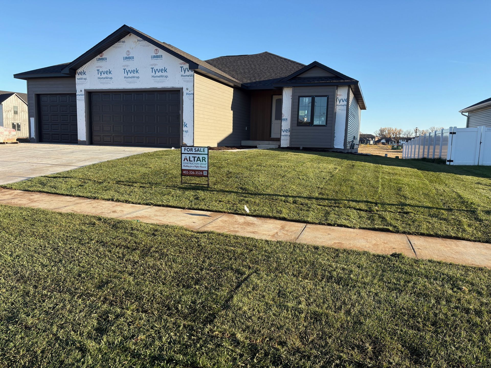 New home with gray siding, garage, and a 