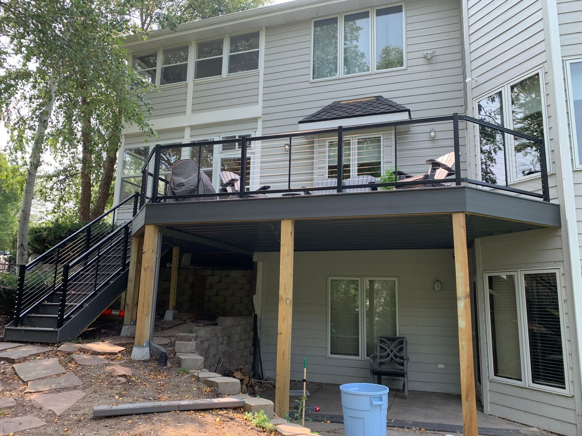 The back of a house with a deck and stairs.