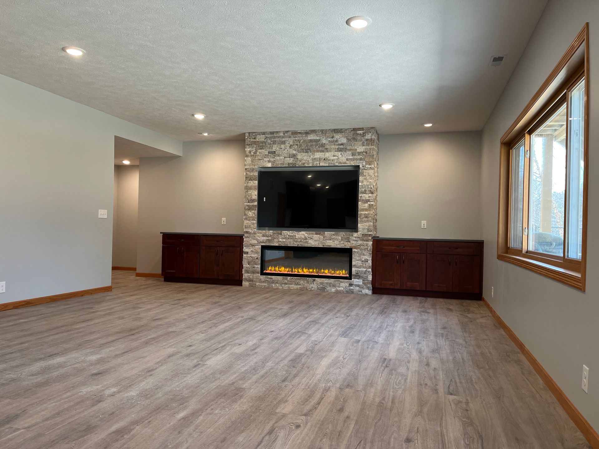 A living room with a fireplace and a flat screen tv.