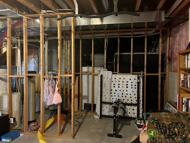 A basement with wooden walls and a couch