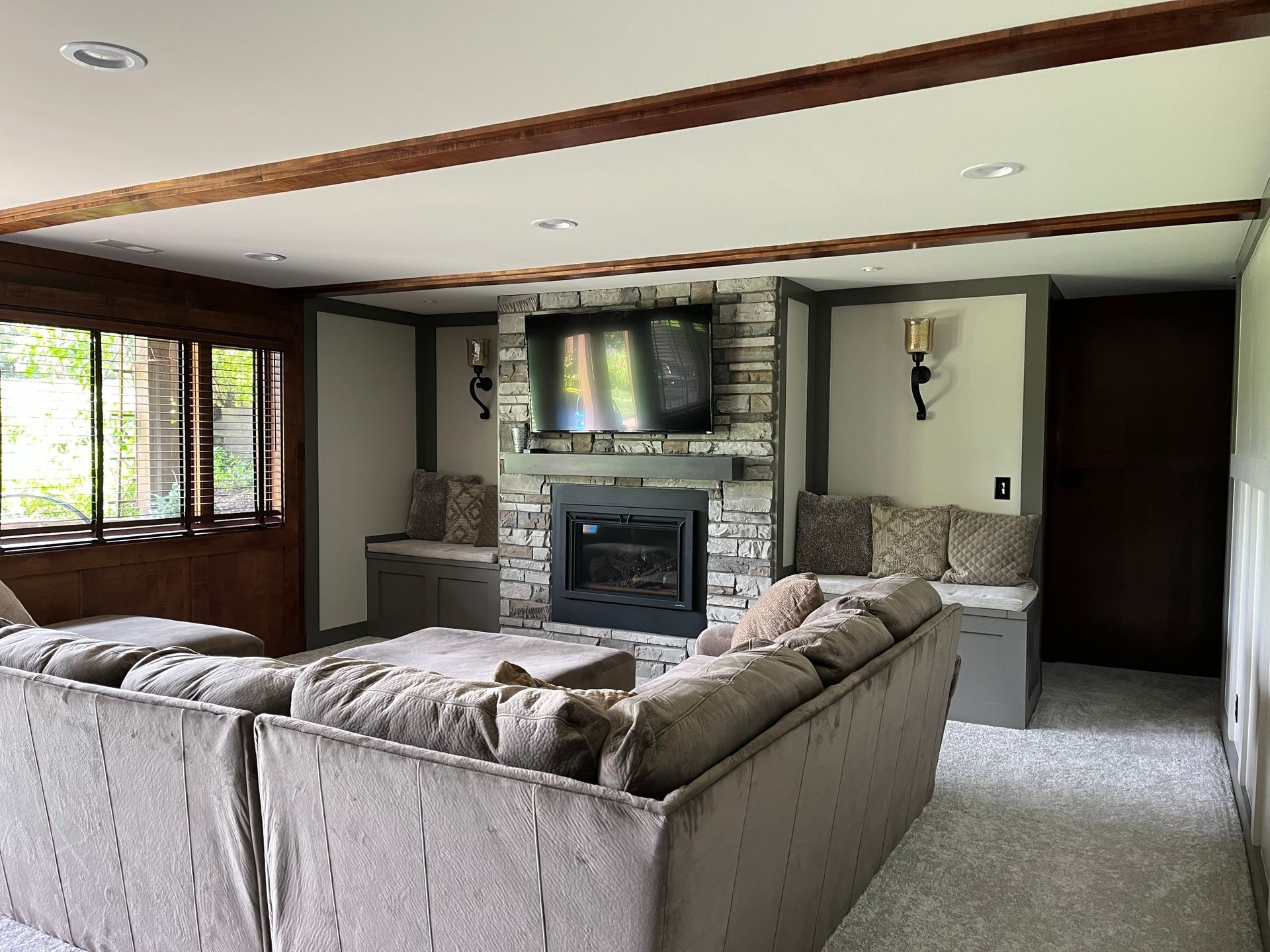 A living room with a couch , fireplace and television.