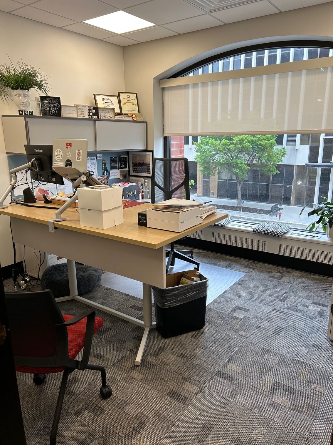 A small office with a desk , chair and window.