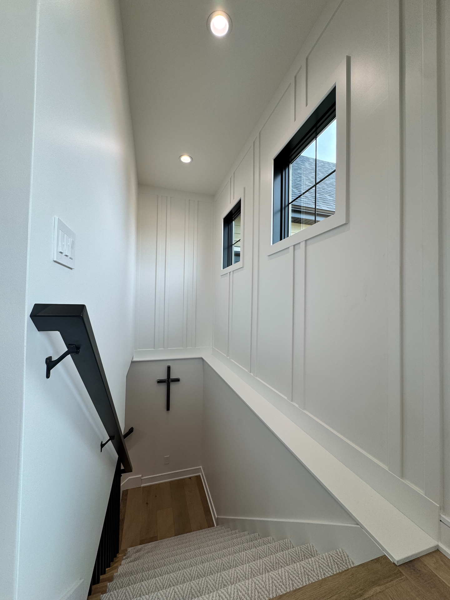 There is a cross on the wall in the middle of the stairs.