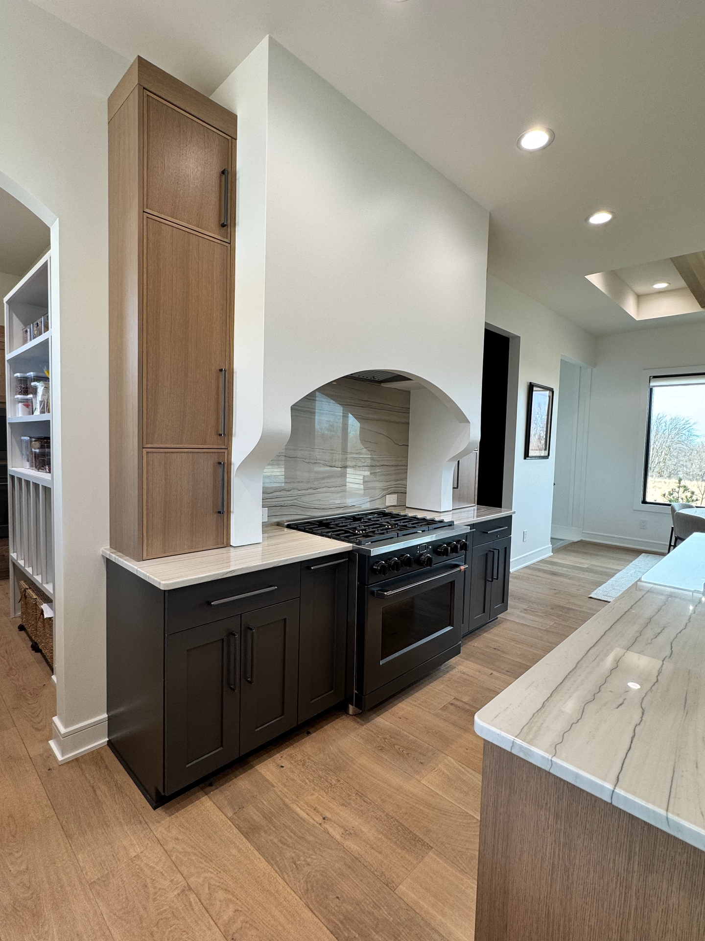 A kitchen with a stove , oven , and cabinets.
