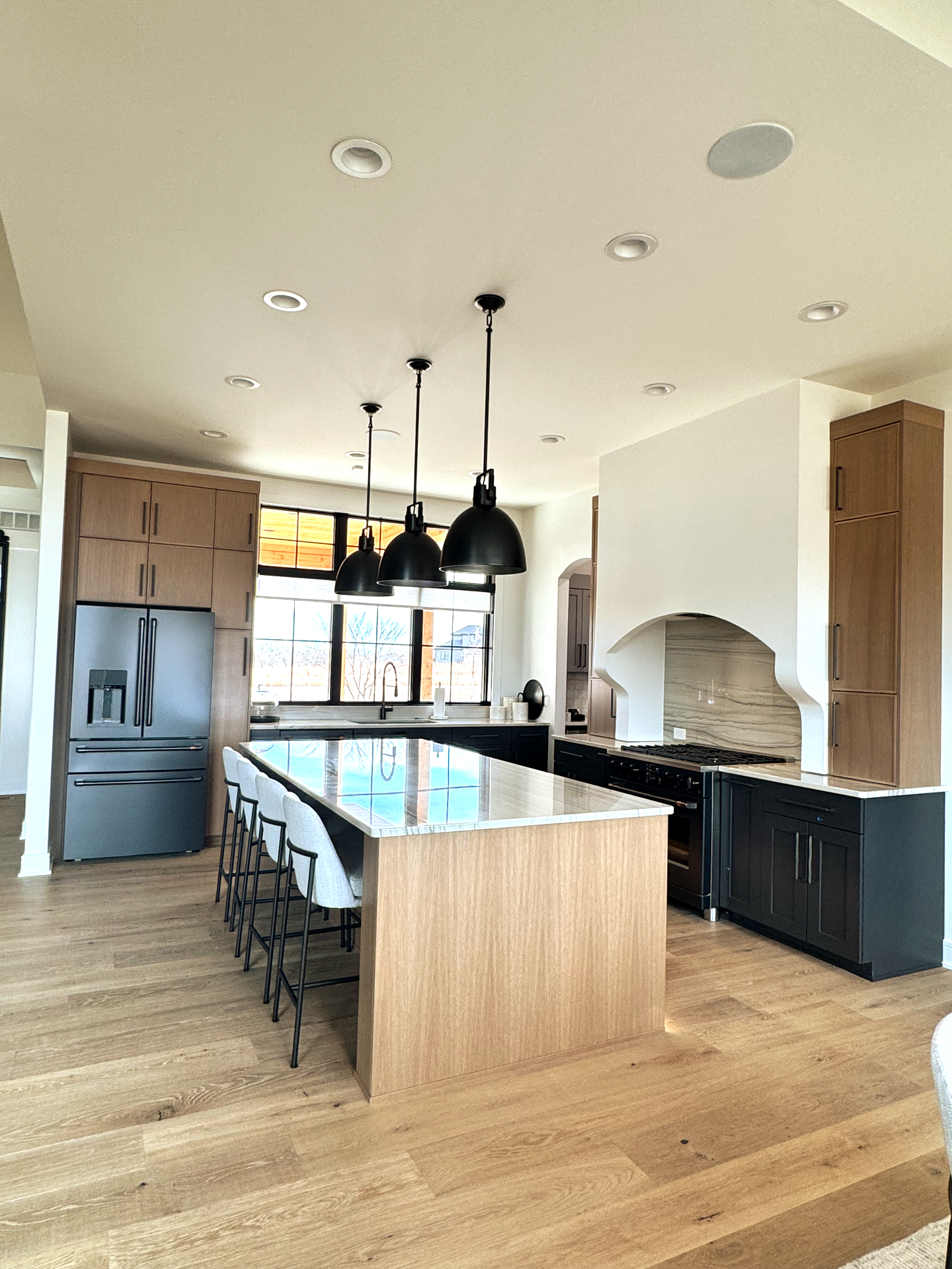 A large kitchen with a large island in the middle of it.
