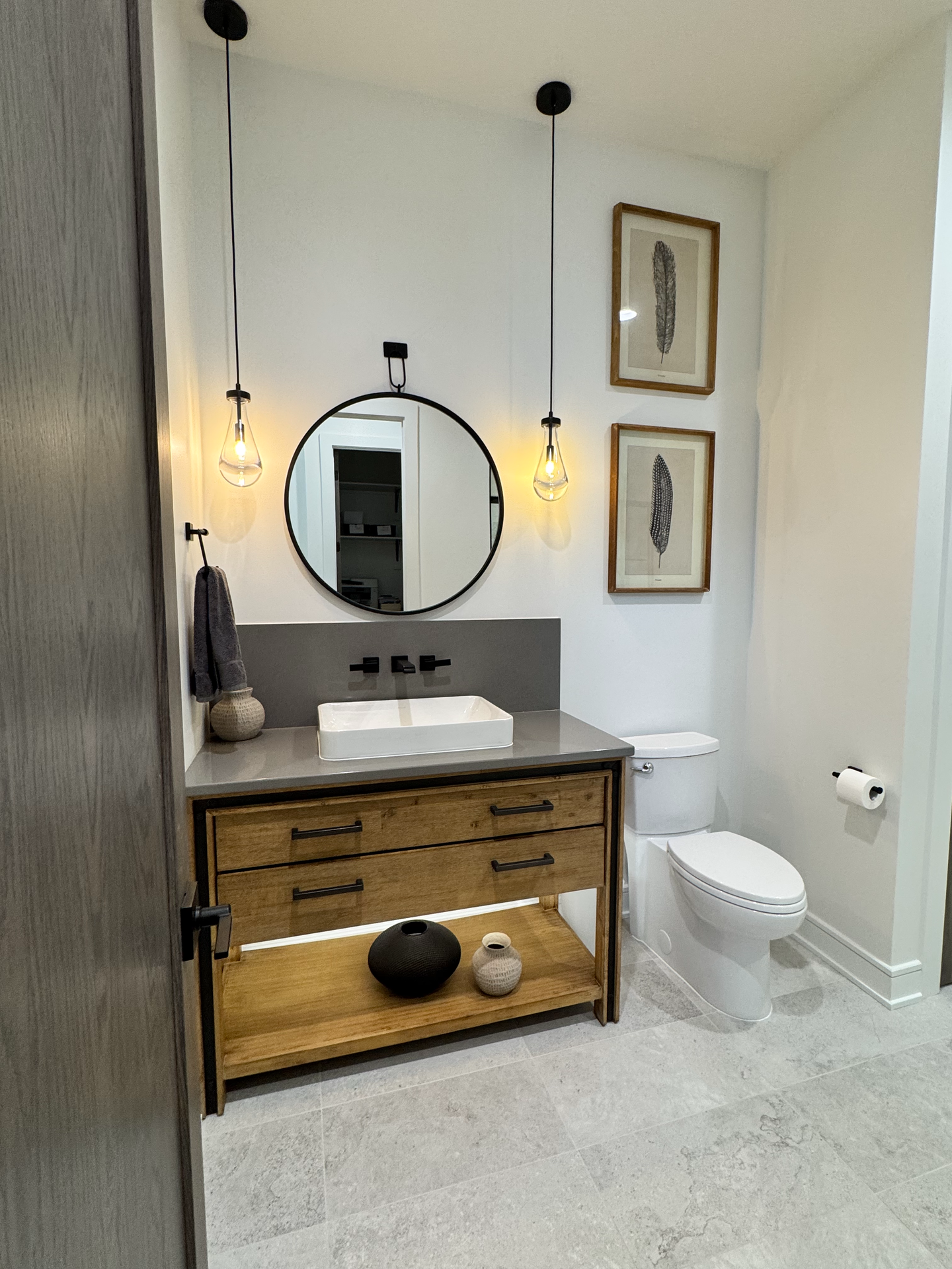 A bathroom with a sink , toilet and mirror.