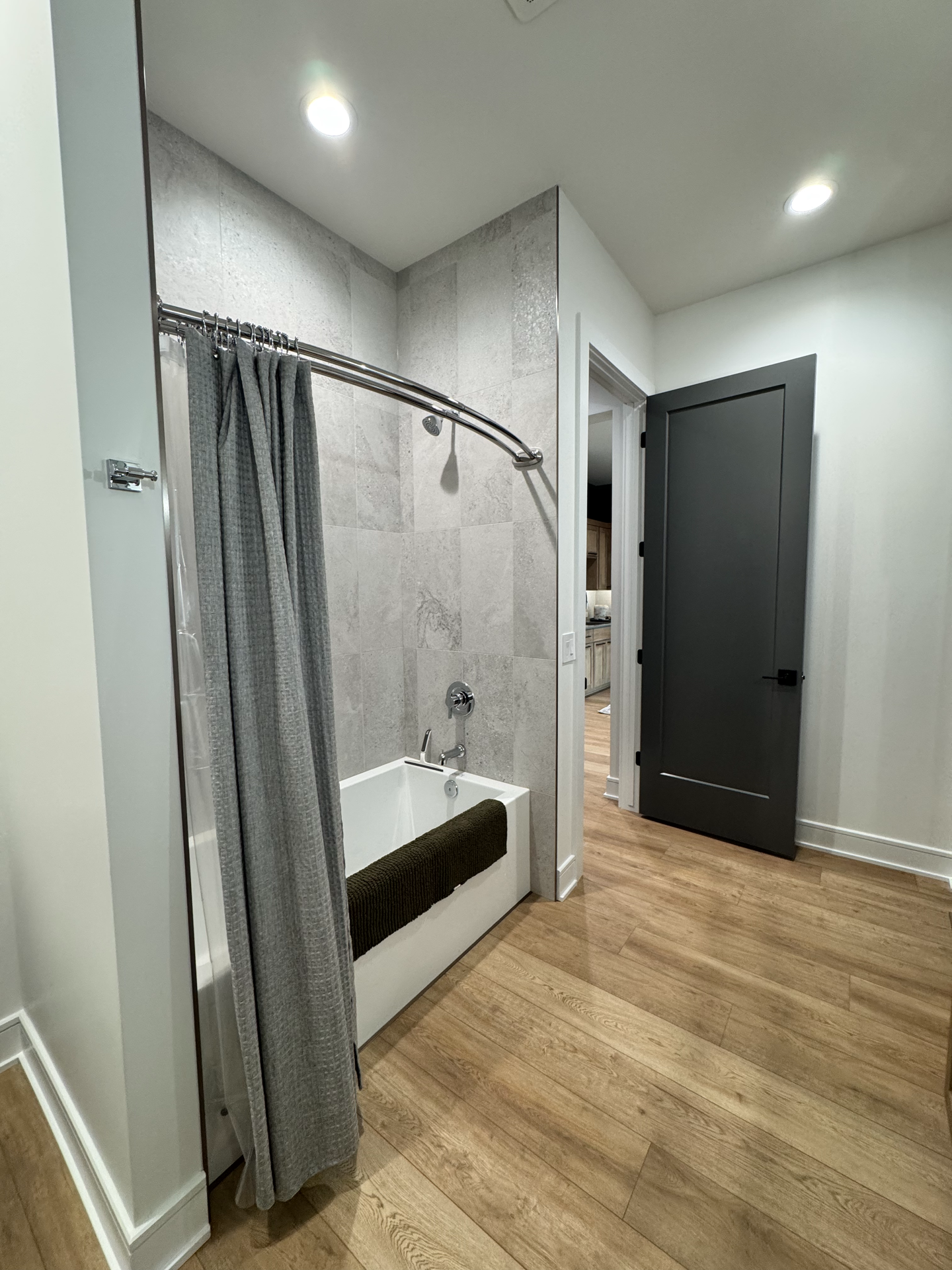 A bathroom with a bathtub and a shower curtain.