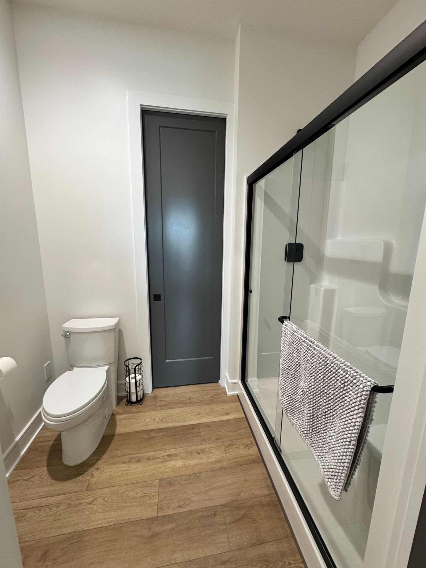 A bathroom with a toilet , shower and bathtub.
