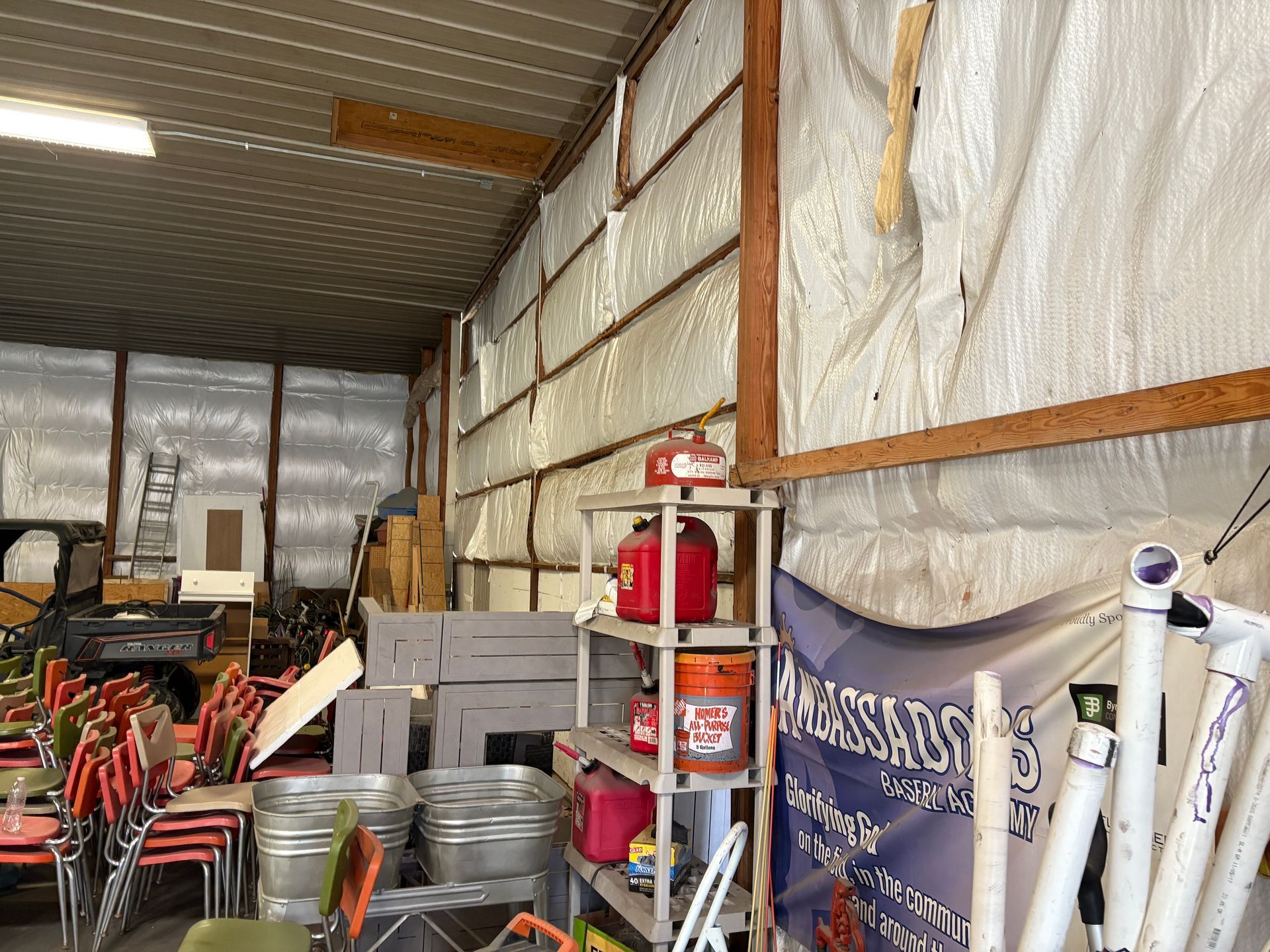 A warehouse filled with lots of buckets and chairs