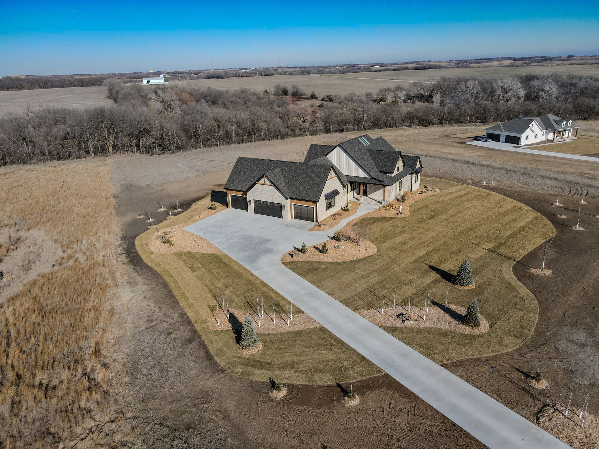 An aerial view of a house in the middle of a field.