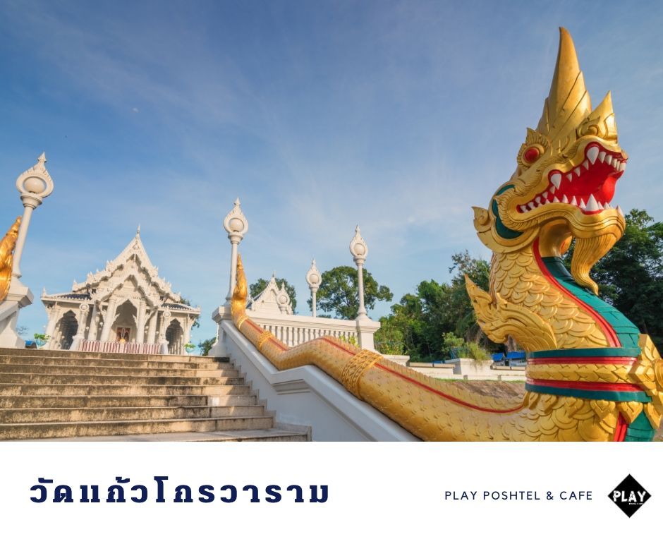 Golden Naga serpent statue and white temple in Thailand.