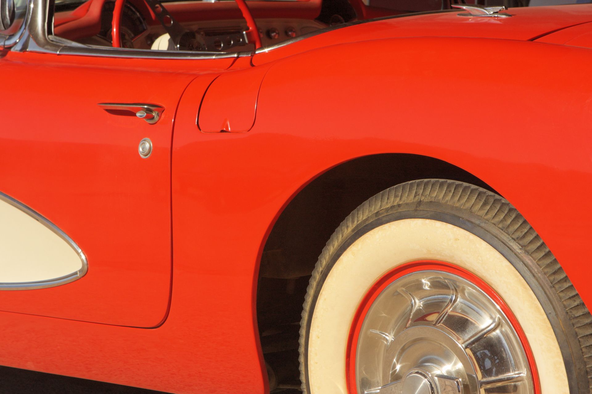 A close up of a red car with white tires