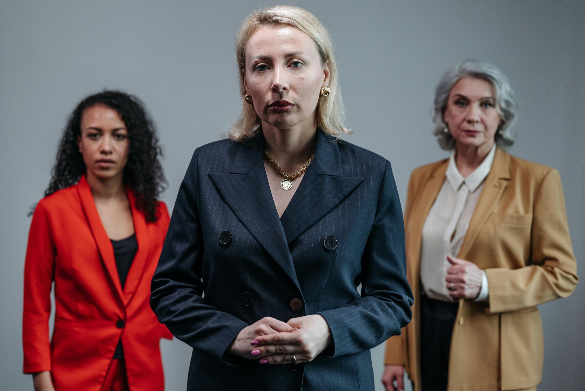 a group of people are sitting around a table looking at papers .