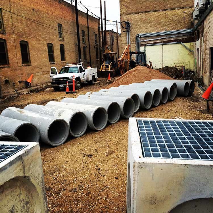 a row of concrete pipes are lined up on a construction site