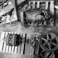 a black and white photo of a bunch of old machinery on a table .