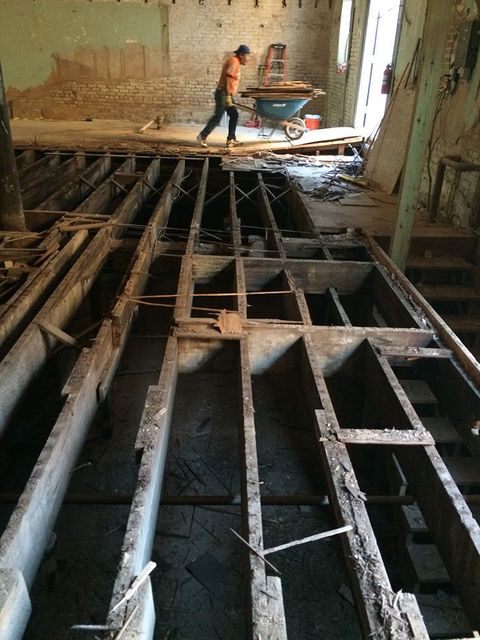 a man is working on the floor of a building