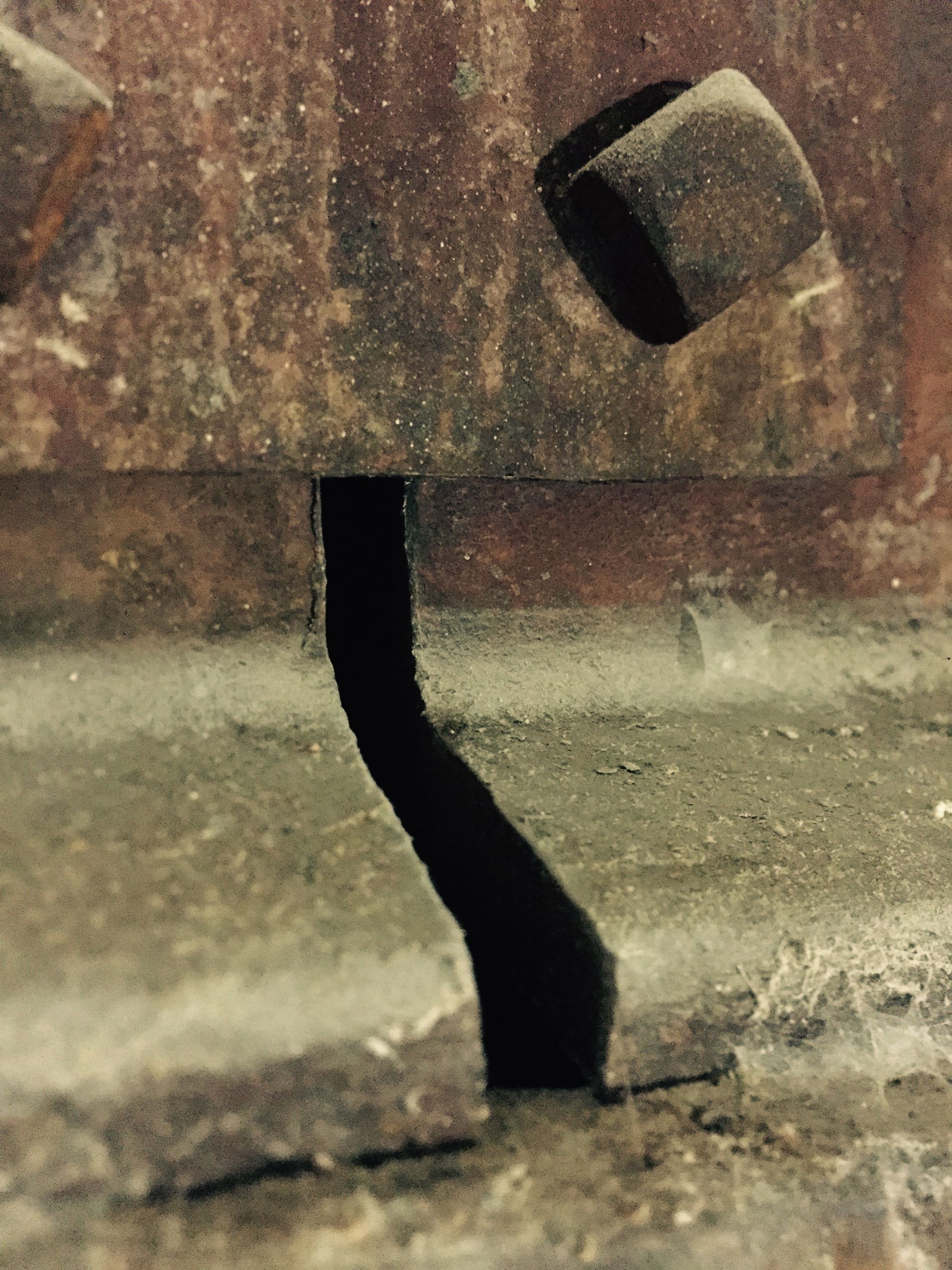 a close up of a piece of metal on the ground .