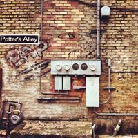 a brick wall with a sign that says potter 's alley on it .