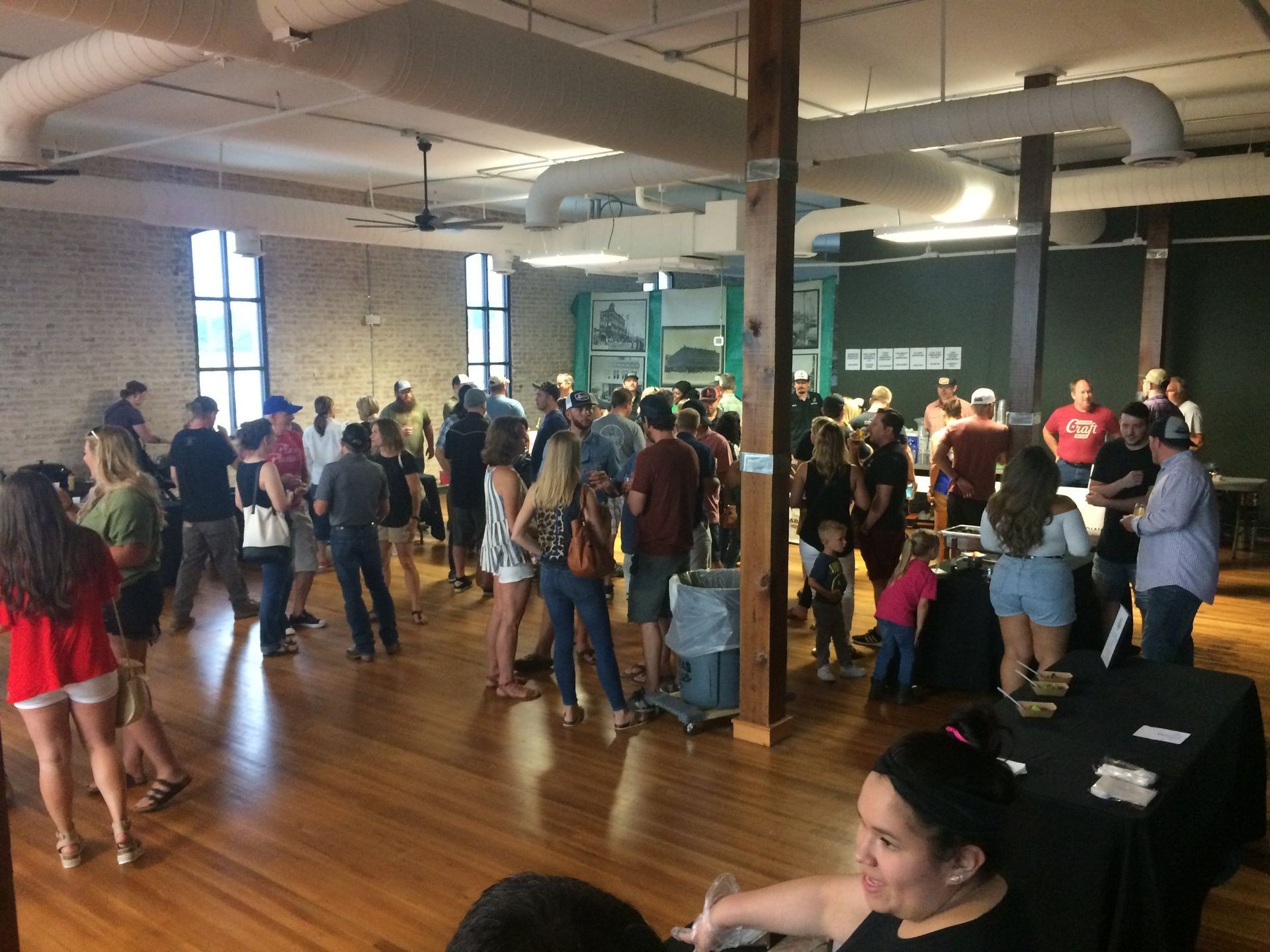 a large group of people are gathered in a large room .