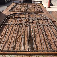 a wrought iron gate is sitting on top of a wooden table .