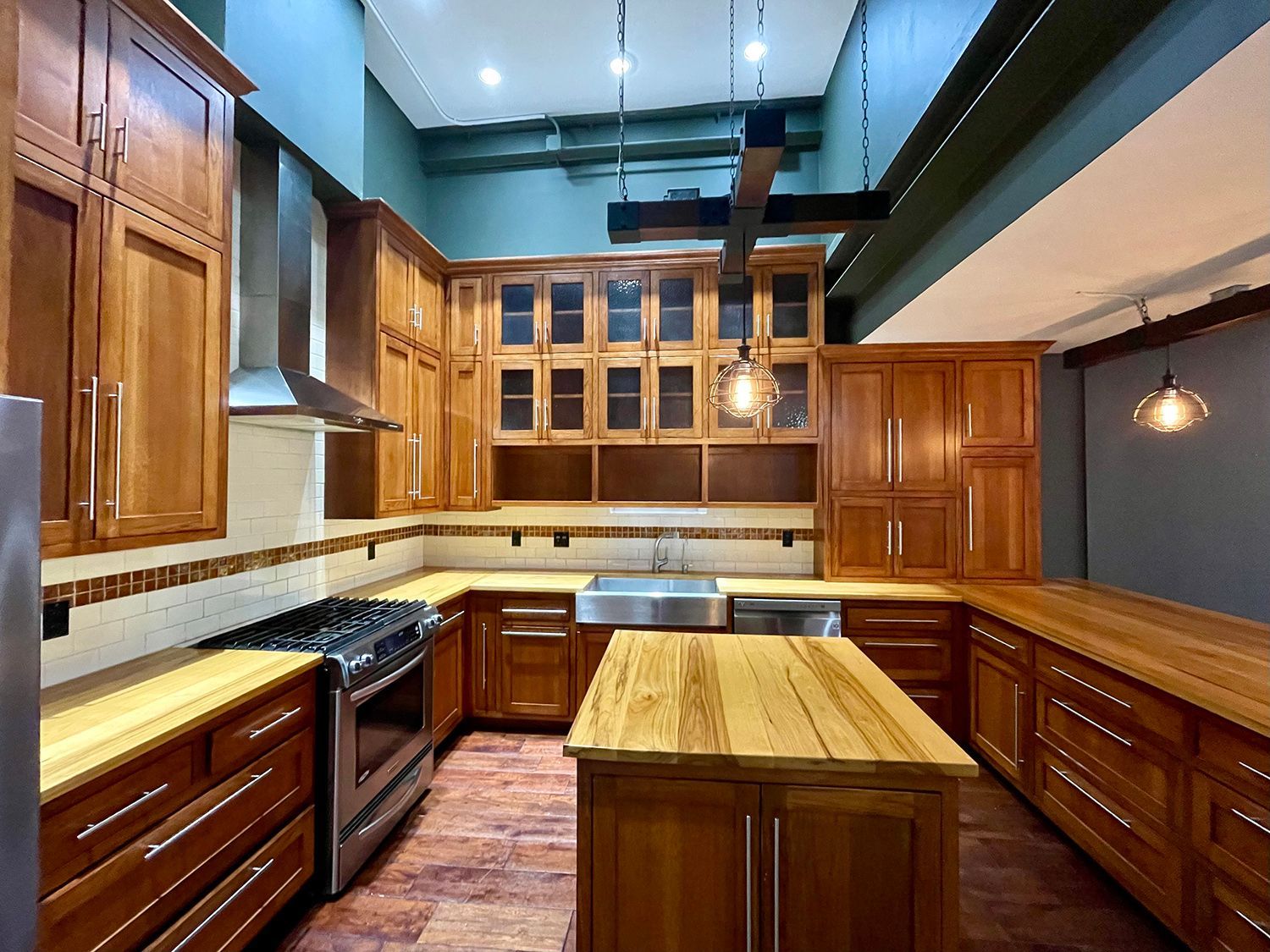 a kitchen with wooden cabinets and stainless steel appliances