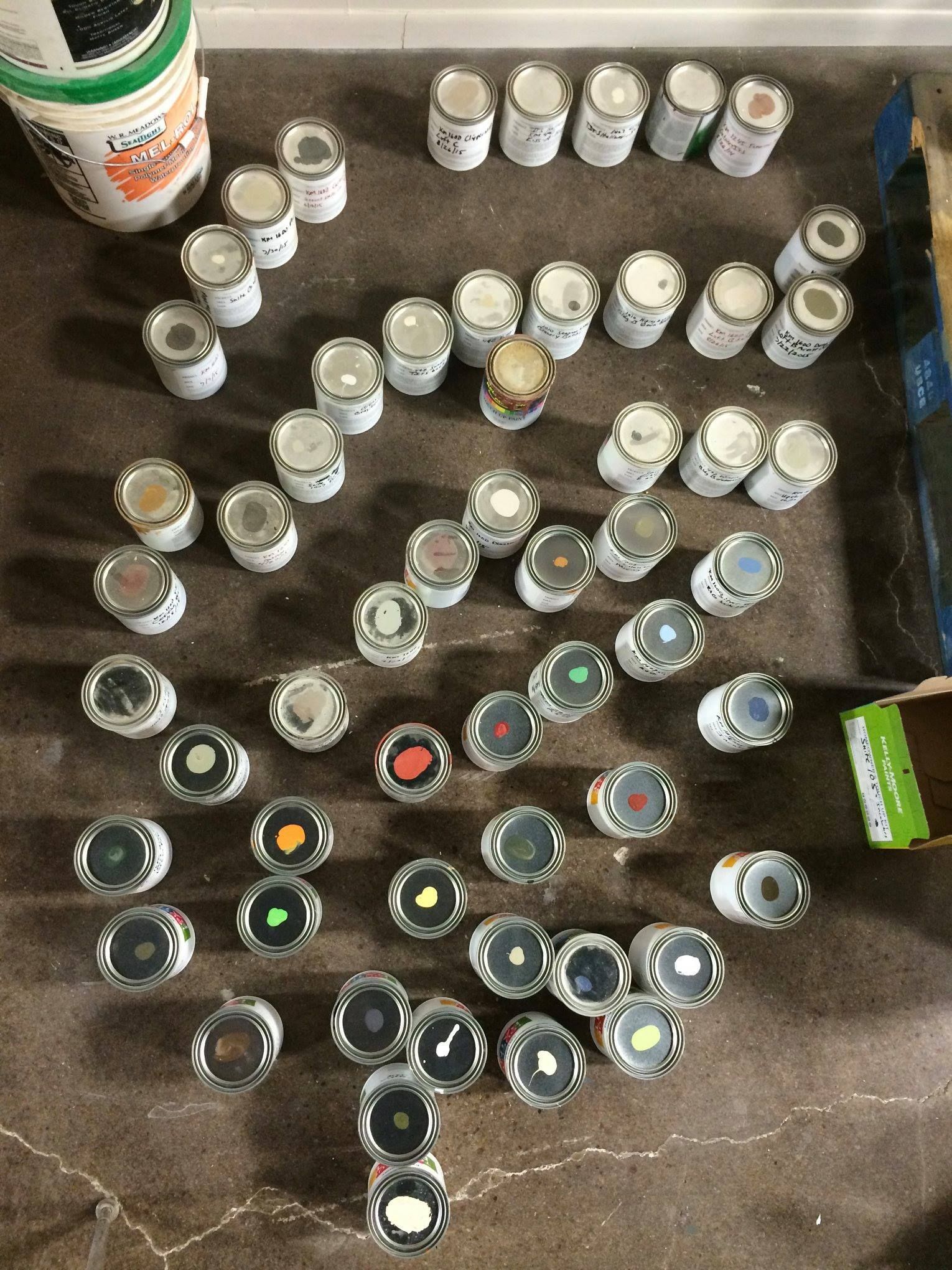 a bunch of cans of paint are sitting on a table .